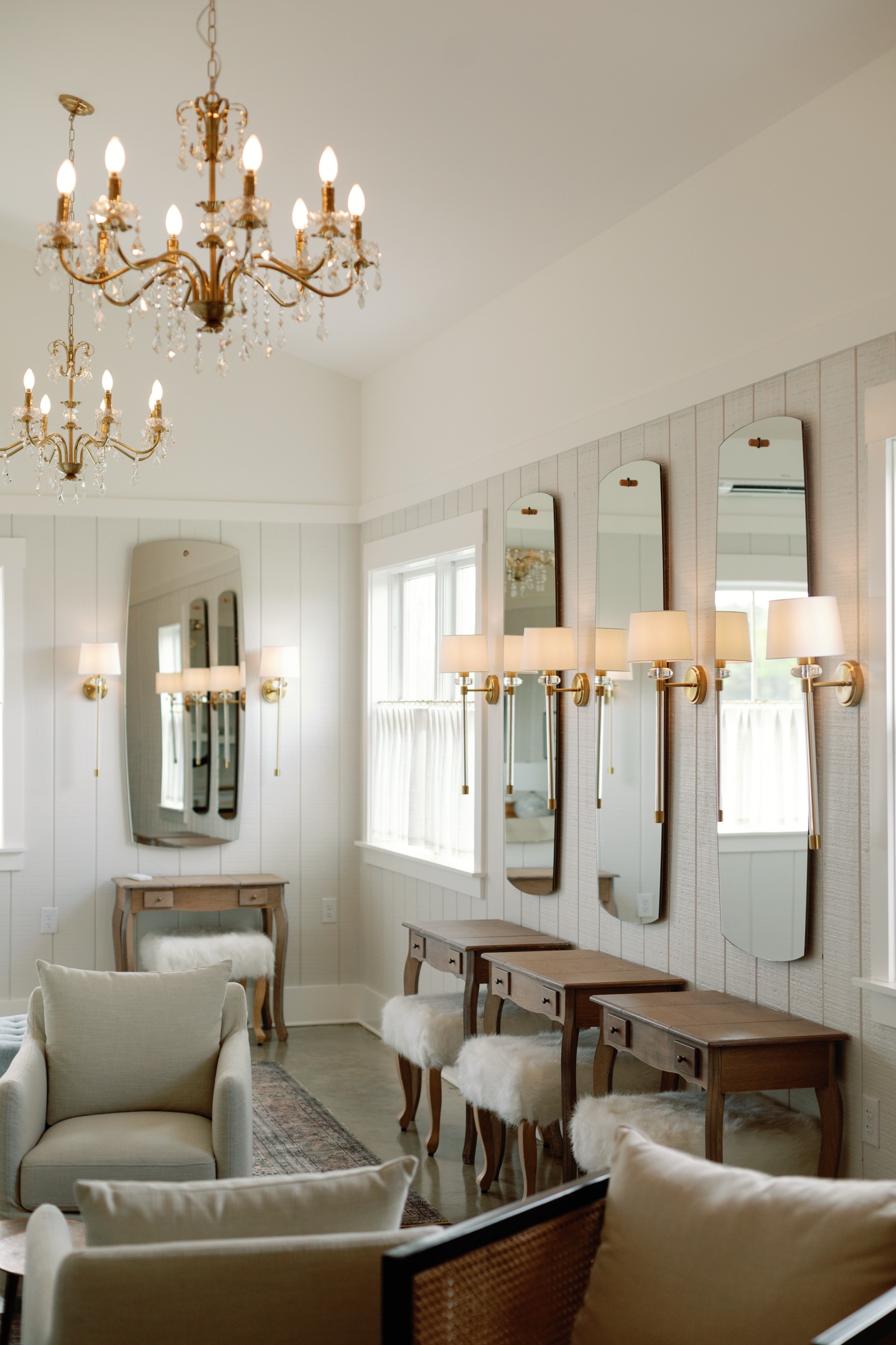 The Bridal Suite's vanities, chandeliers and soft seating in window light